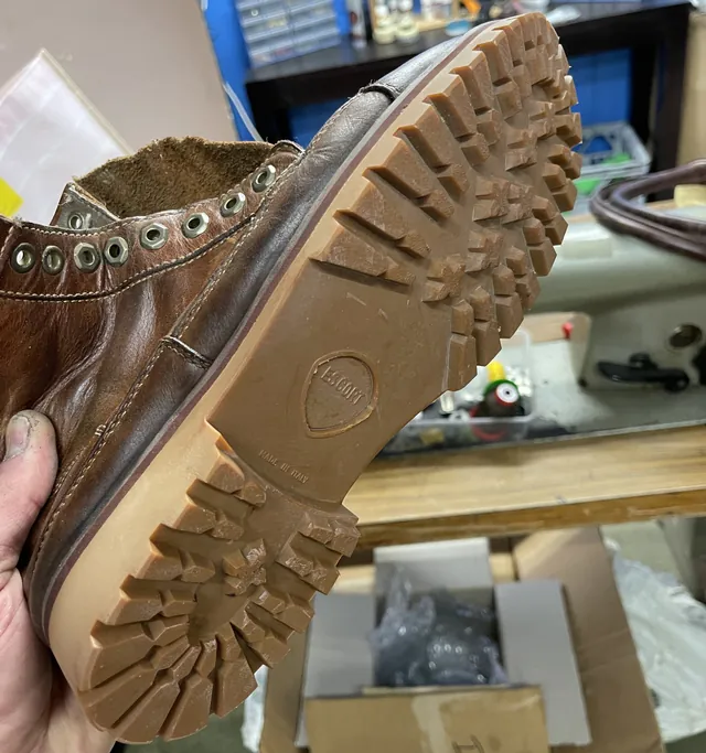 A brown leather boot with a brand new chunky rubber lug sole